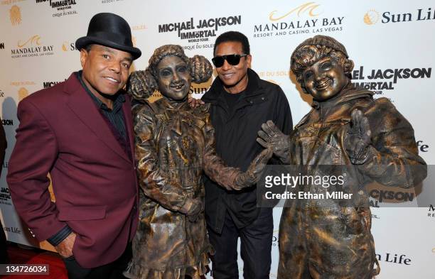 Tito Jackson and Jackie Jackson pose with Cirque du Soleil performers as they arrive at the Las Vegas premiere of Michael Jackson THE IMMORTAL World...