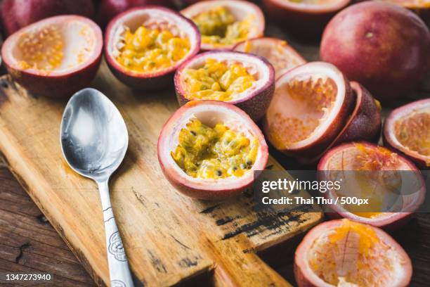 high angle view of passion fruits on table,ho chi minh city,ho chi minh,vietnam - maracuja stock-fotos und bilder