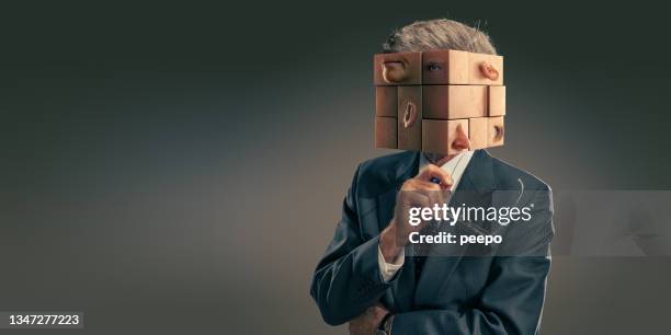 portrait of business man in suit with head as scrambled puzzle pieces - rubiks kub bildbanksfoton och bilder