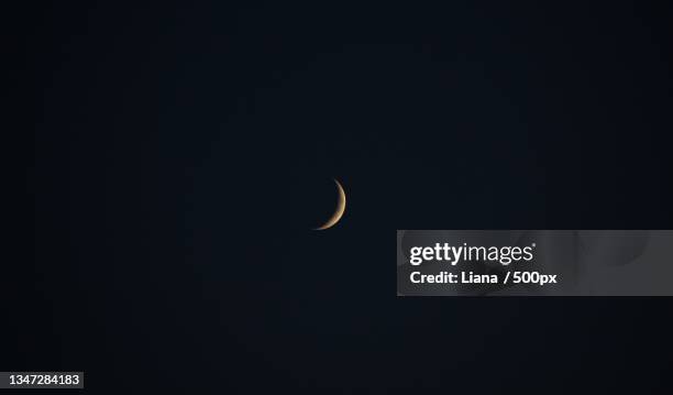 low angle view of moon against sky at night - crescent stock pictures, royalty-free photos & images