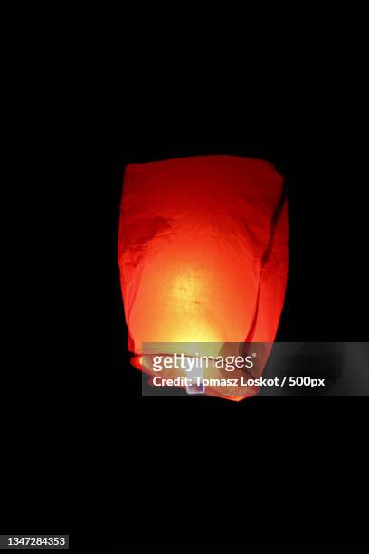 low angle view of illuminated paper lantern against sky at night - rislampa bildbanksfoton och bilder