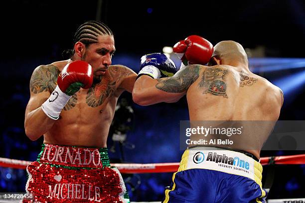 Antonio Margarito of Mexico throws a punch against Miguel Cotto of Puerto Rico in the first round during the WBA World Junior Middleweight Title...