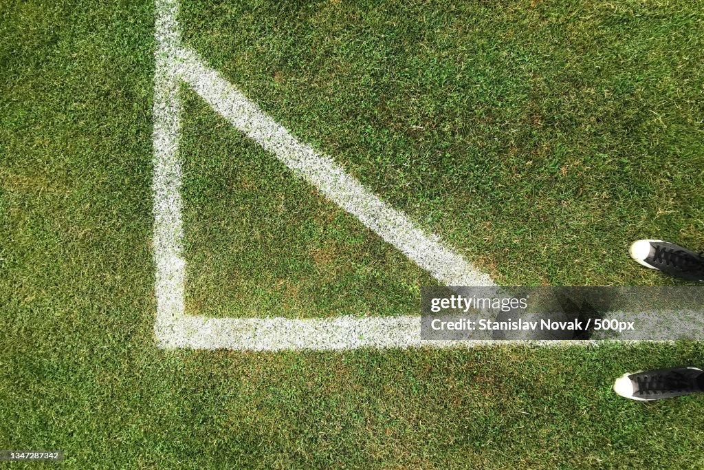 Low section of person playing soccer on field
