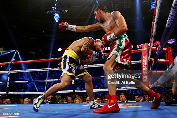 Miguel Cotto of Puerto Rico dunks under the punch of Antonio Margarito of Mexico during the WBA World Junior Middleweight Title fight at Madison...