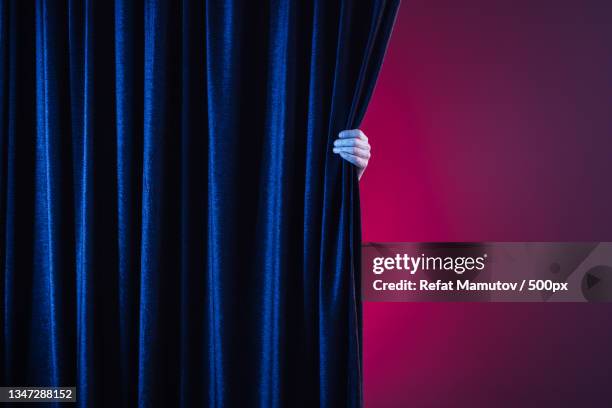 midsection of woman holding curtain while standing against curtain - velvet stock pictures, royalty-free photos & images