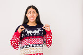 christmas gift become a bad santa idea on a unhappy woman, ugly sweater for christmas celebration