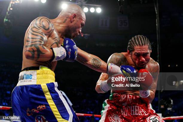 Miguel Cotto of Puerto Rico connects with a left handed punch against Antonio Margarito of Mexico during the WBA World Junior Middleweight Title...