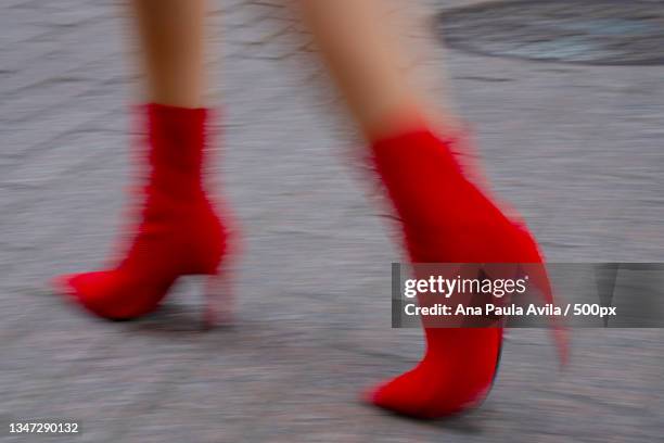 low section of woman walking on road - fashion high heels stock pictures, royalty-free photos & images