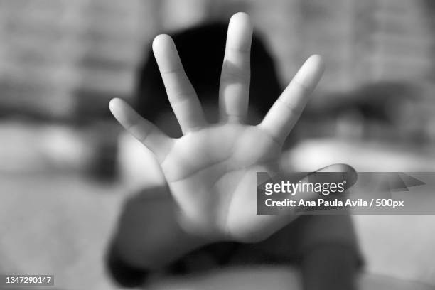 close-up of woman showing stop gesture - child abuse stock-fotos und bilder
