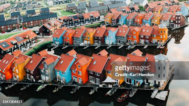 an aerial view of colourful waterfront apartments at dusk - stock photo - netherlands sunset stock pictures, royalty-free photos & images