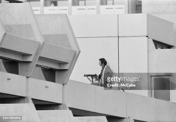 An armed police officer maintains surveillance in the Athletes' Village during the 1972 Munich Olympic Games in Munich, West Germany, after...