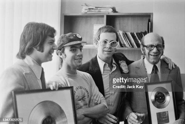 From left to right, music publisher Stephen James, songwriter Bernie Taupin, singer and pianist Elton John and Stephen's father, music publisher Dick...