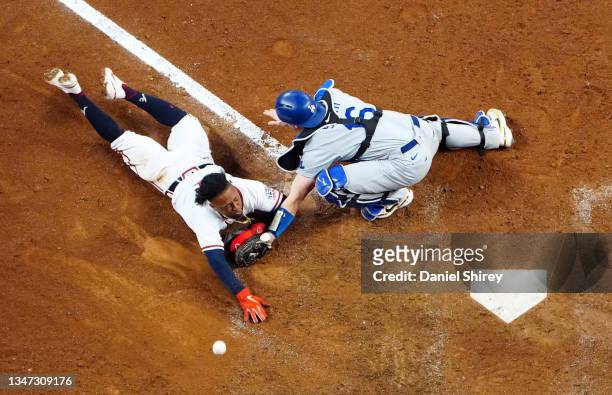 Ozzie Albies of the Atlanta Braves slides home to score in the eighth inning of Game 2 of the NLCS between the Los Angeles Dodgers and the Atlanta...