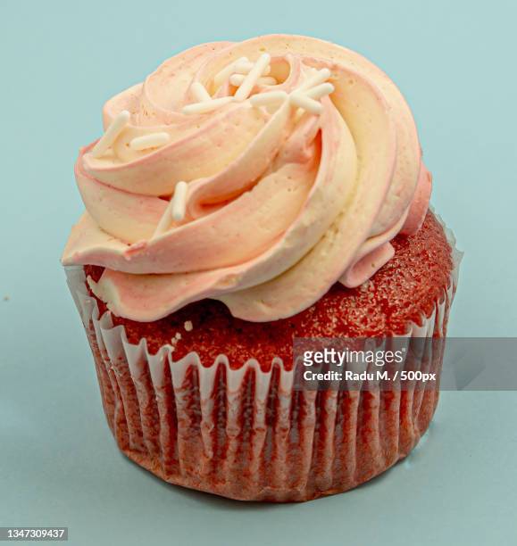 close-up of cupcake against blue background - forma de queque imagens e fotografias de stock