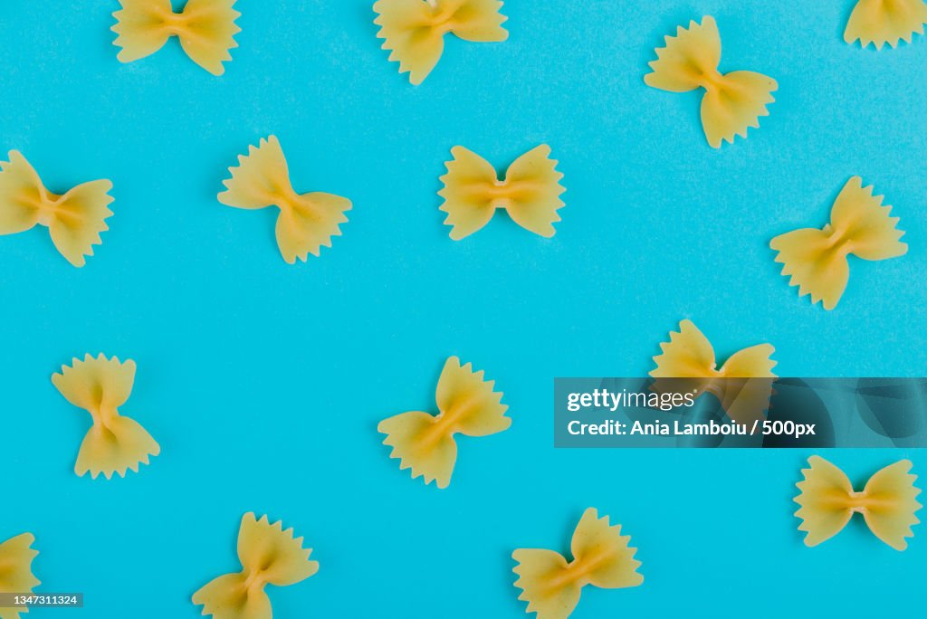 Directly above shot of yellow pasta on blue background