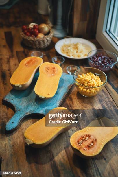 preparing burrito butternut squash boats - butternut squash stock pictures, royalty-free photos & images