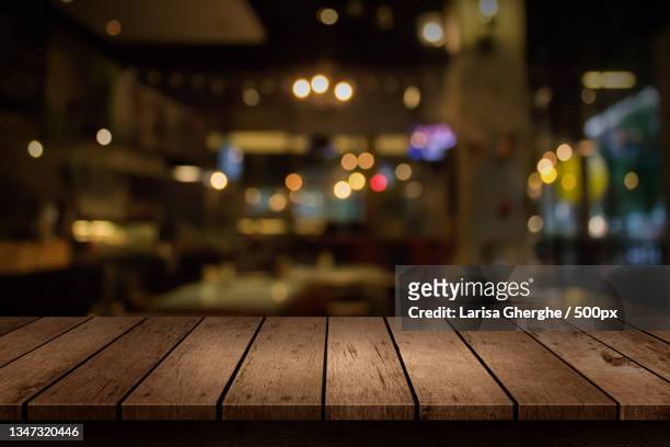 close-up of wooden table in restaurant - バーカウンター ストックフォトと画像