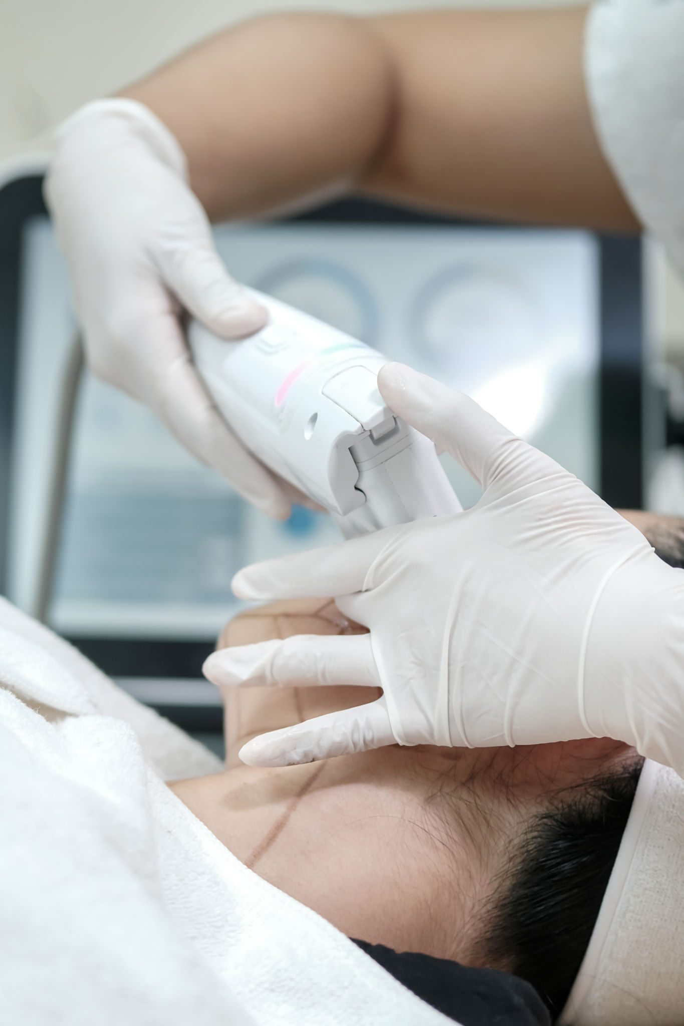 Close up of woman receiving HIFU therapy- high intensity focused ultrasound treatment on face. Therapist doing non-surgical cosmetic plasma lift with ultrasonic device. SMAS lifting Close up of woman receiving HIFU therapy- high intensity focused ultrasound treatment on face. Therapist doing non-surgical cosmetic plasma lift with ultrasonic device. SMAS lifting