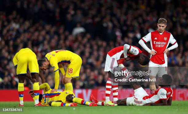 Cheikhou Kouyate of Crystal Palace and Thomas Partey of Arsenal go down injured during the Premier League match between Arsenal and Crystal Palace at...