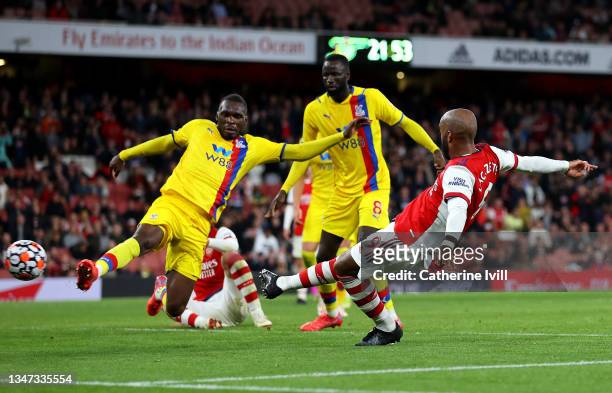 Alexandre Lacazette of Arsenal scores their team's second goal past Christian Benteke of Crystal Palace during the Premier League match between...