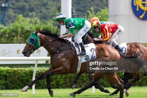 October 17: Jockey Zac Purton riding Cheerful Days wins the Race 2 IWC Schaffhausen Excellent Handicap at Sha Tin Racecourse on October 17, 2021 in...