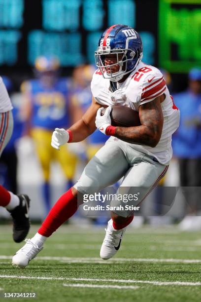 Devontae Booker of the New York Giants carries the ball during the first half against the Los Angeles Rams at MetLife Stadium on October 17, 2021 in...