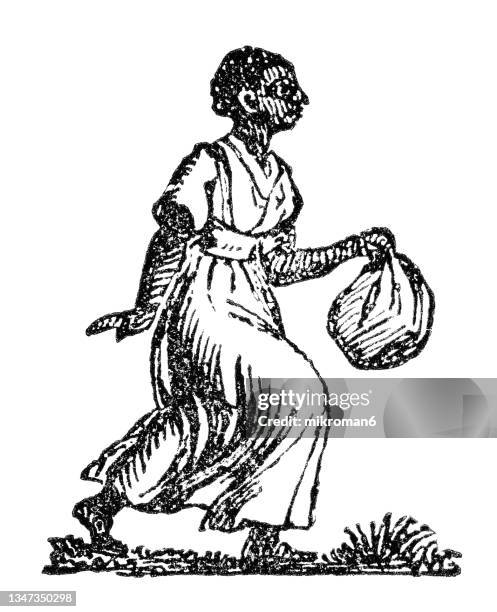 old engraved illustration of woman walking with bundle - black woman slave stock pictures, royalty-free photos & images