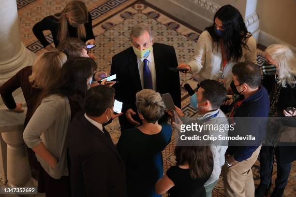 Senate Majority Whip Richard Durbin talks with reporters in the hallway outside the Senate Chamber at the U.S. Capitol on October 18, 2021 in...
