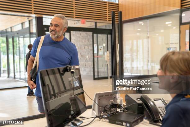 checking members into the computer system - gym receptionist stock pictures, royalty-free photos & images
