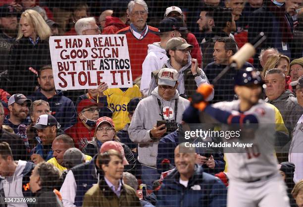 Sign referring to the Houston Astros cheating is held by a fan during the Boston Red Sox game against the Houston Astros in Game Three of the...