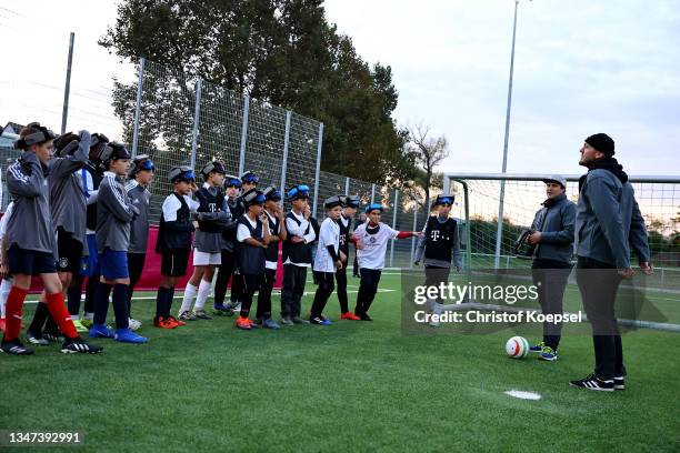 Hasan Koparan, blind-football national player of Germany and player and Birk Gebauer, coach DFB Base Camp Bonn teach young footballer during the...