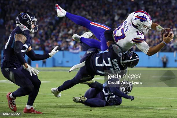 Quarterback Josh Allen of the Buffalo Bills is tackled short of the first down marker on third down by safety Amani Hooker of the Tennessee Titans...