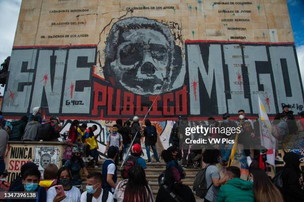 Demonsttrators paint a mural with the face of Alvaro Uribe, that reads 'Public enemy' as thousands protest in northern Bogota, Colombia on May 12,...