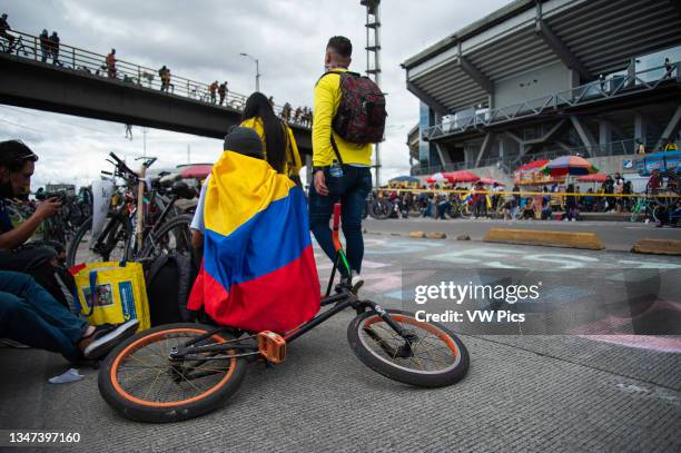 Demonstrator wearing a Colombian flag protests in front of El Campin football stadium against the Copa America as Colombia enters its 4th week of...