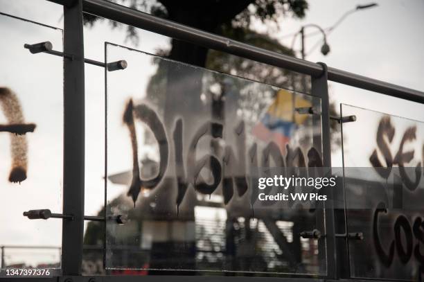 The word Dignity seen with a Colombian flag on the back as thousands protested during the marking of the first month of anti government strikes...