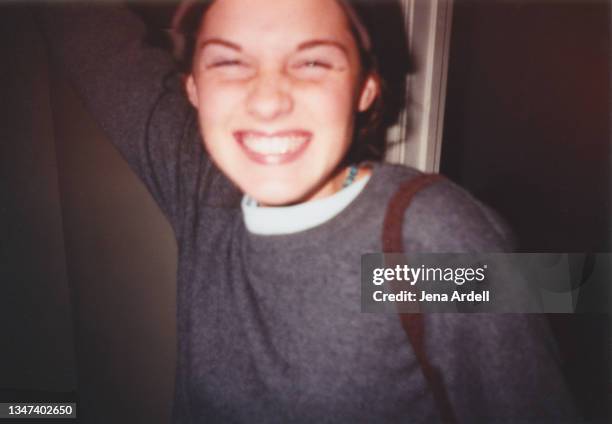 happiness: vintage 90s teenager candid moment smiling with toothy grin - defocussed photos stock pictures, royalty-free photos & images