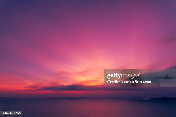 a cloudy and colorful sunset on the ocean - puesta de sol romántica fotografías e imágenes de stock