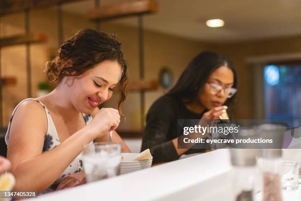 teenage female friends eating beans and meat chili together afro-latinx lifestyle in the us photo series - female eating chili bildbanksfoton och bilder