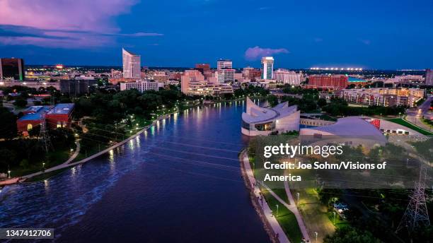 Drone aerial view of downtown Wichita Skyline features Arkansas Rivers, bridges and Exploration Place Science Museum, Kansas.