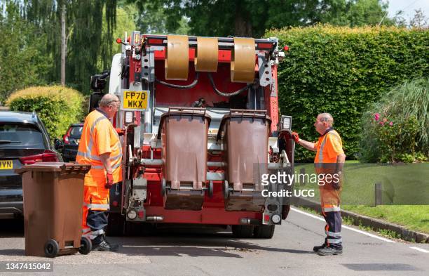 Hampshire, England, UK, Council operatives collect garden waste which is transported in the truck to be composted, bagged and sold on.