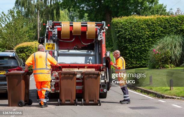 Hampshire, England, UK, Council operatives collect garden waste which is transported in the truck to be composted, bagged and sold on.