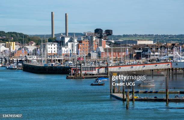 Cowes, Isle of Wight, England, UK, Cowes viewed along the waterfront of the River Medina showing chimneys of the power station, marinas and landing...