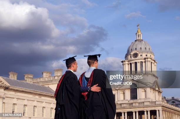 Male students at the University of Greenwich posing for pictures on graduation day in the grounds of the Old Royal Naval College in London.