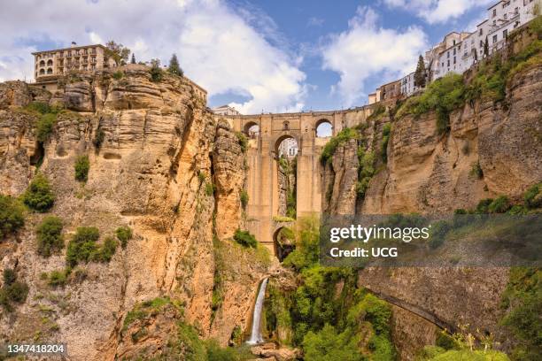 Ronda's Tajo gorge spanned by the Puente Nuevo, or New Bridge. The Guadalevin River runs through the gorge. Ronda, Malaga Province, Andalusia,...