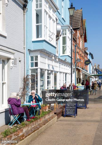 Regatta restaurant, Aldeburgh, Suffolk, England, UK sunny day people sitting outside on street.