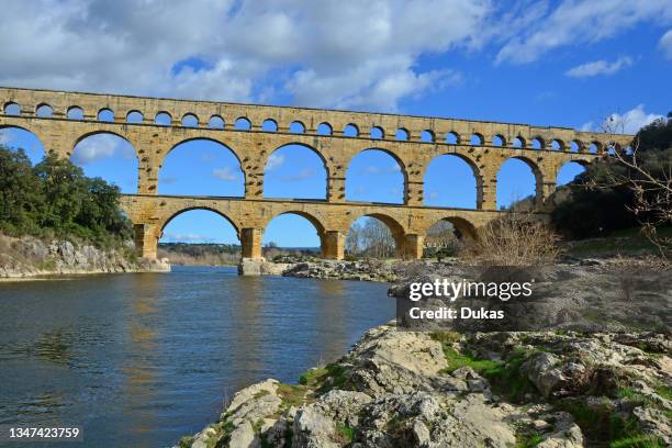 The Ancient Roman Pont du Gard aqueduct and viaduct bridge over the River Gardon, the highest of all ancient roman bridges, near to Nimes in the...