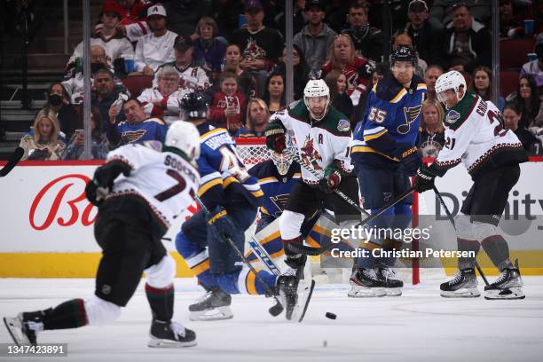 Andrew Ladd and Loui Eriksson of the Arizona Coyotes attempt to tip a shot from Victor Soderstrom during the second period of the NHL game at Gila...