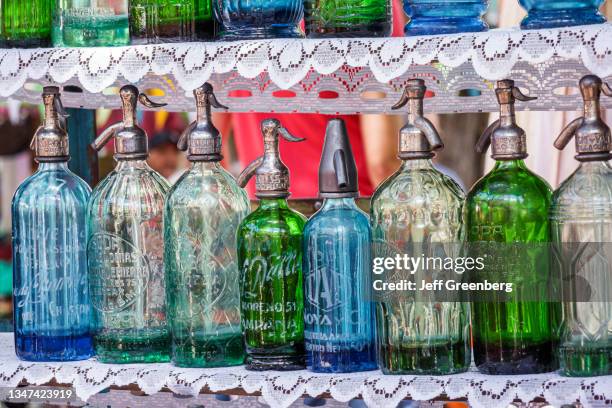 Argentina, Buenos Aires, Plaza Dorrego, open-air antiques market, vintage seltzer bottles.