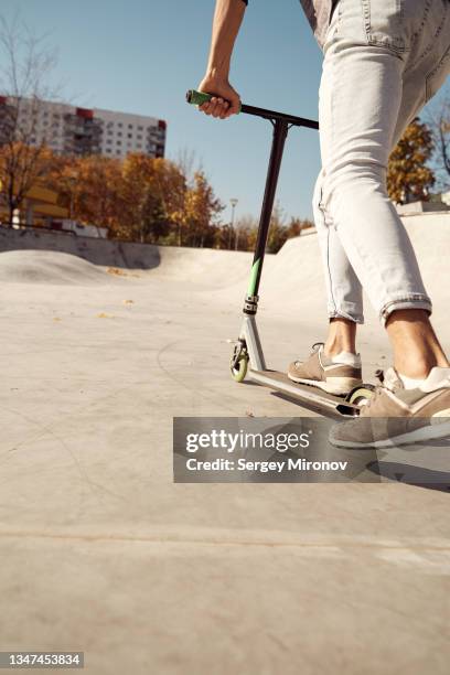 young man skating on scooter in skateboard park - scooter stock pictures, royalty-free photos & images