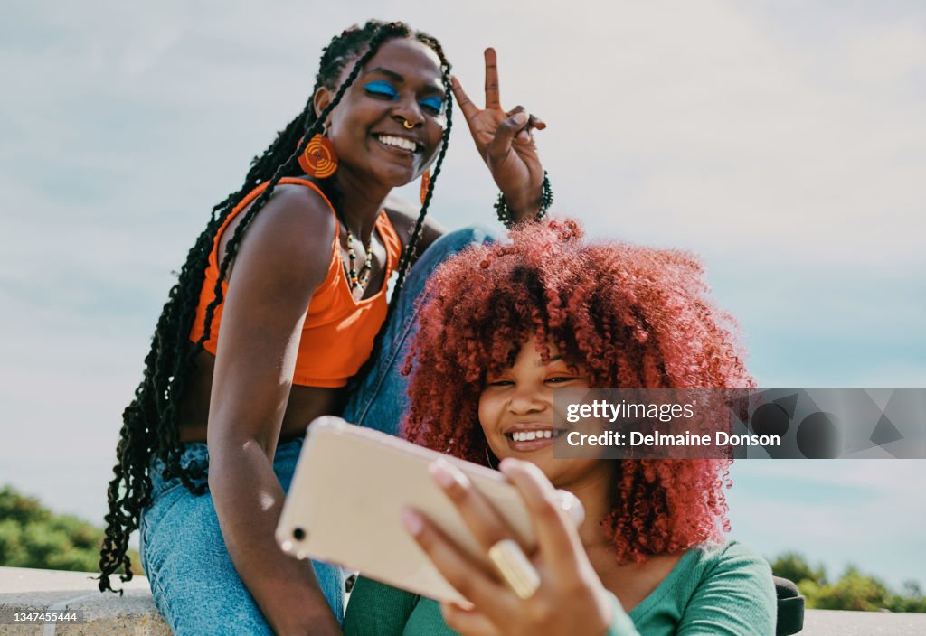 Shot of two young female friends taking a selfie in the city